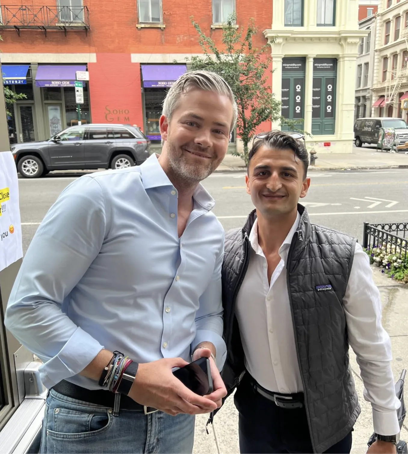 Giovanni Mulè and Ryan Serhant smiling for a photo on a New York street outside Serhant HQ
