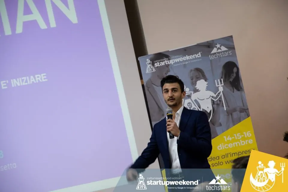 Giovanni on stage at Startup Weekend by Techstars